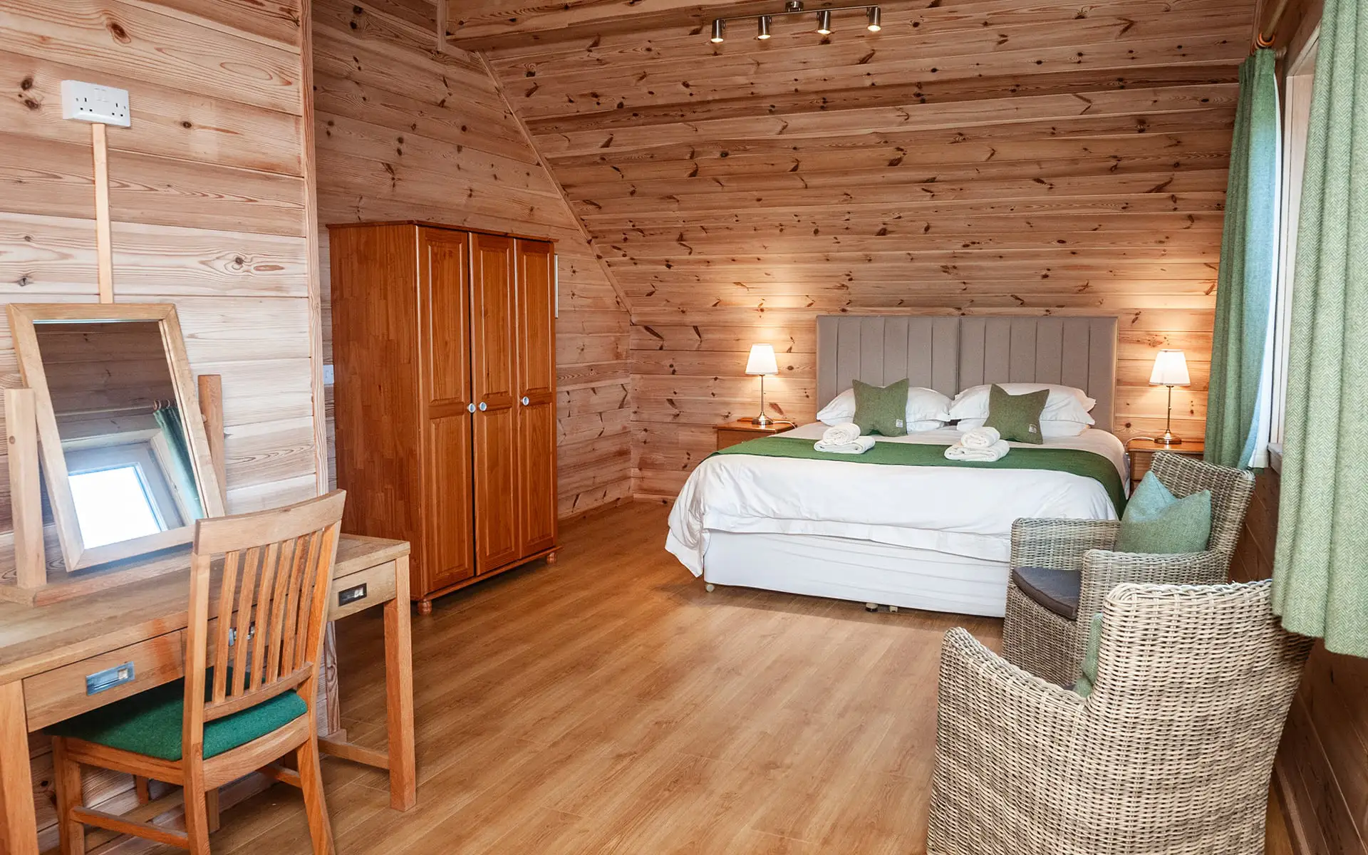 Large Luxury Cottage Room with wooden walls and floors, king size bed and wooden furniture