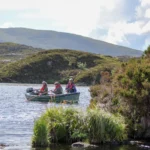 3 Fishermen on a small boat fishing on the Isle of Harris
